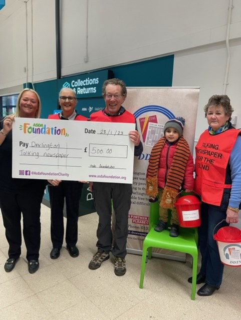 Members of Darlngton Talking Newspaper being presented with a large cheque from staff at Asda's Whinfield Store in Darlington.